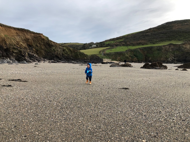 Cornwall with kids: Hemmick Beach - Reuben running along beach laughing
